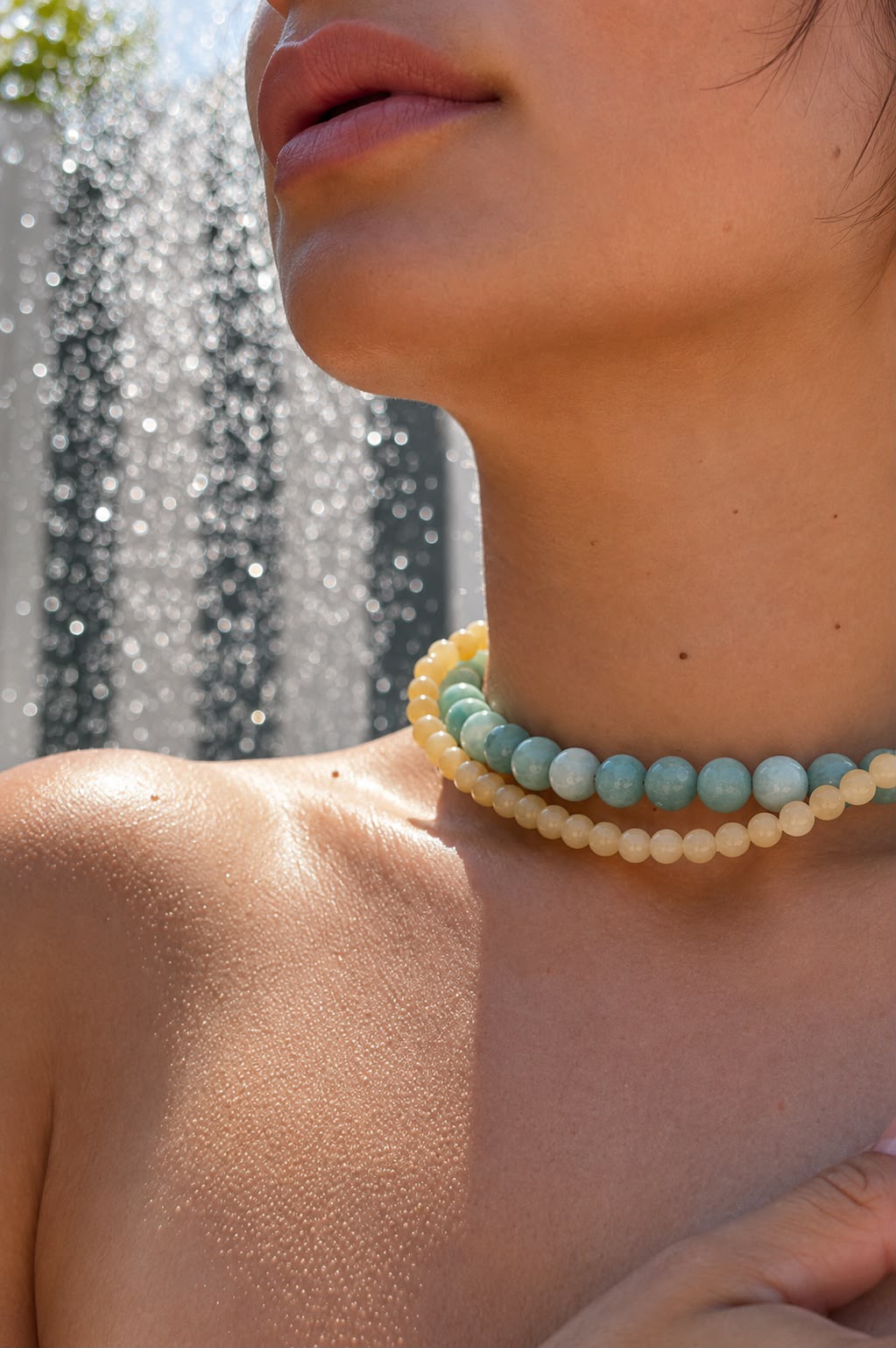 Two-strand turquoise and cream stone necklace worn in the sun